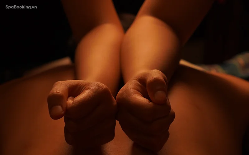 Luxurious six hands massage therapy session in a serene spa setting.