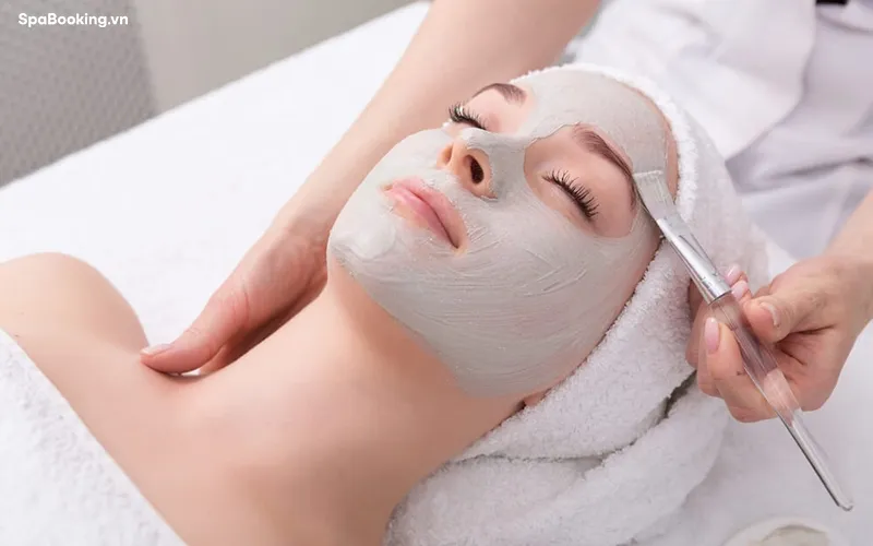 Relaxing facial treatment in Hoi An's serene spa setting.
